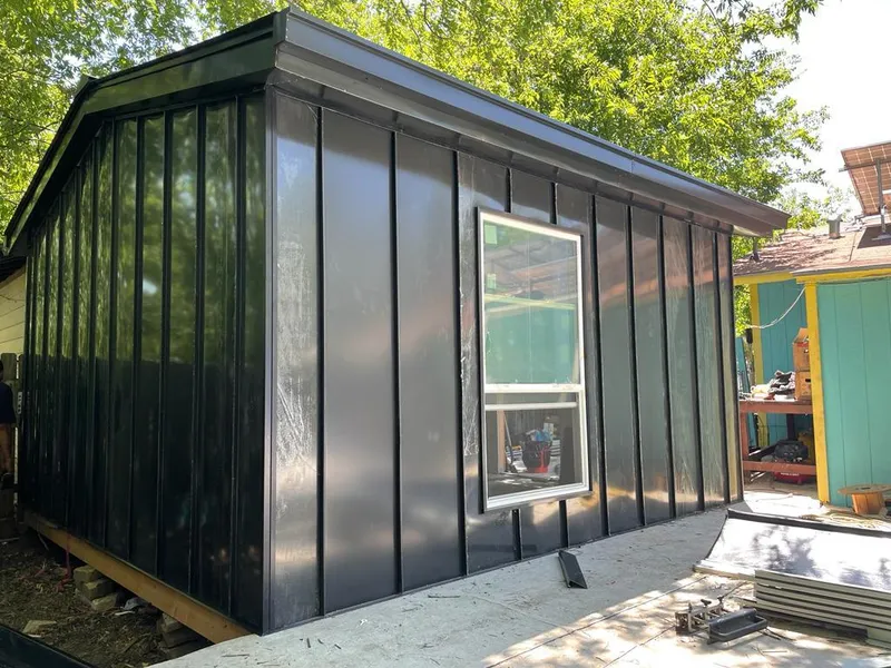Black standing seam metal wall panels for Roof Inspection in Lackland AFB