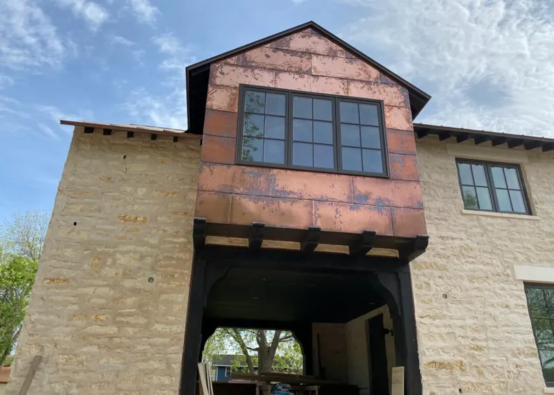 Copper metal panel facade on a stone building for Metal Roof Coating in Lackland AFB